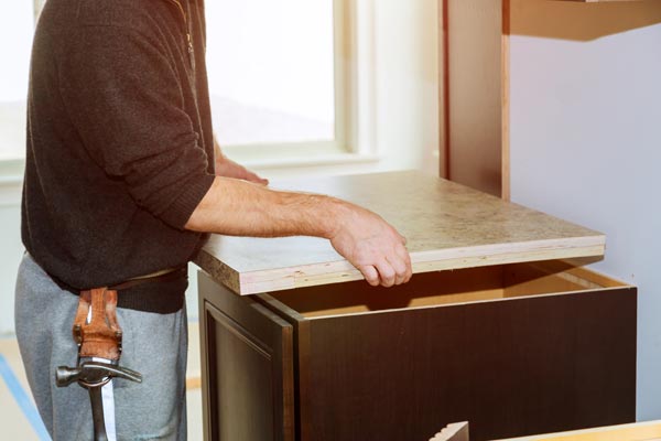 Image of a person working to kit countertop