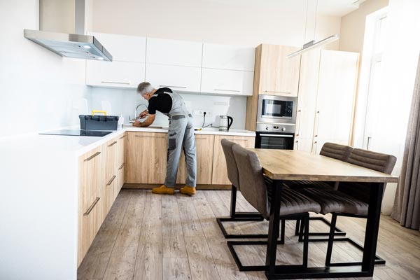 Image of a person working to kit countertop