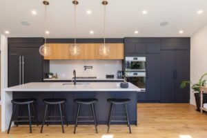 Image of a kitchen with countertop, chairs and sink
