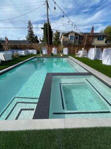 Image of a backyard with sitting area and swimming pool