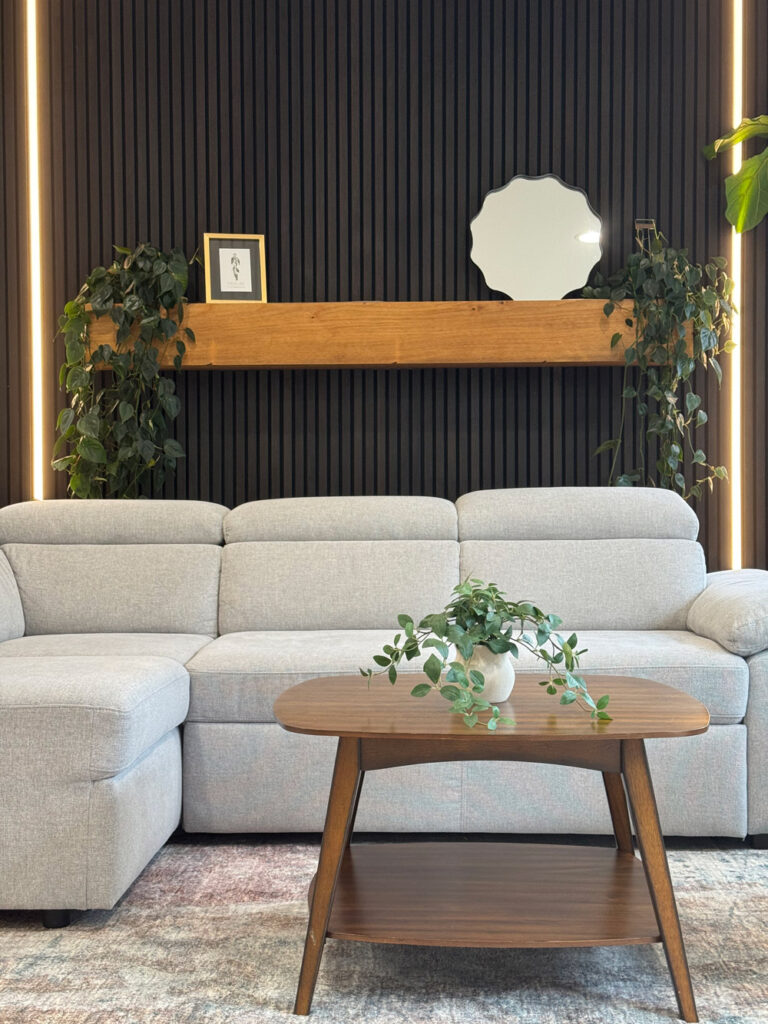 Redwood City home remodel mantel detail, a chunky oak beam shelf spanning the black slat wall above the LED reveals.